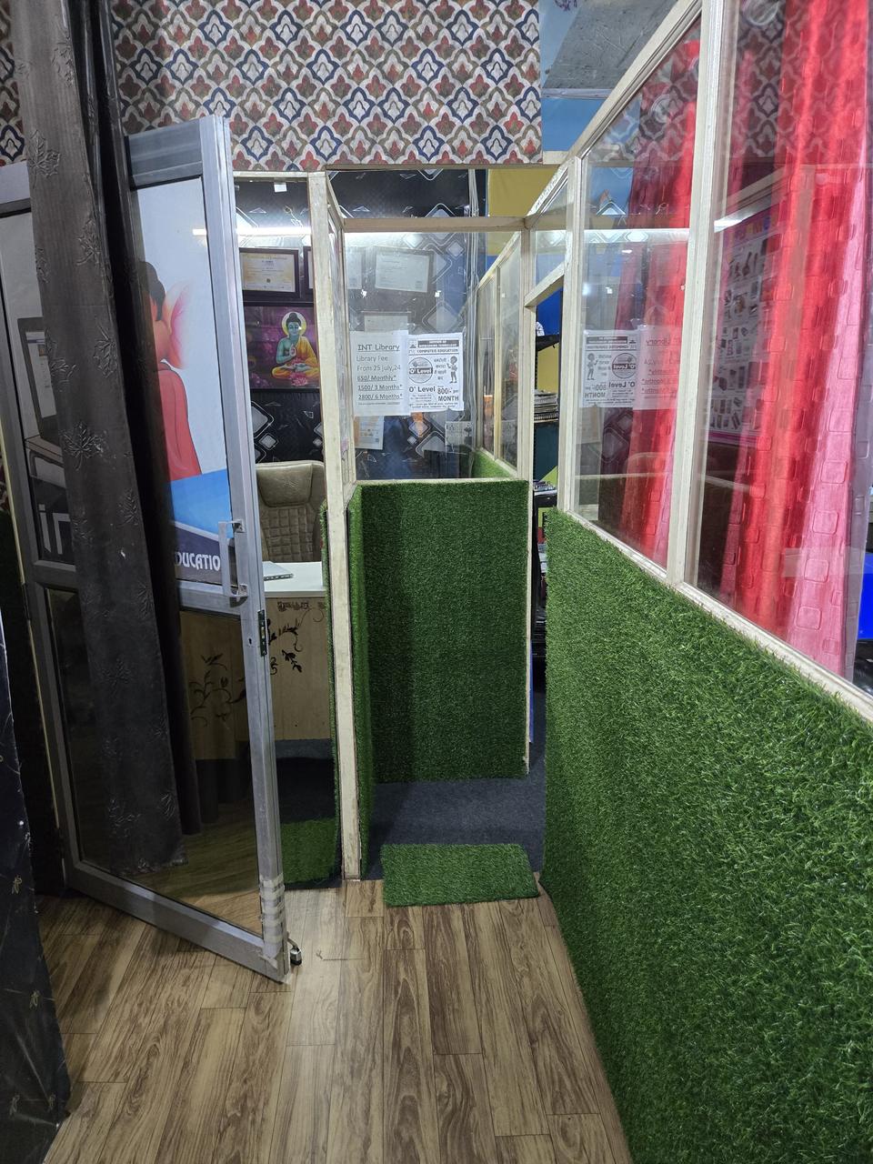 Entrance area at VidyaTech with glass-partitioned cabins