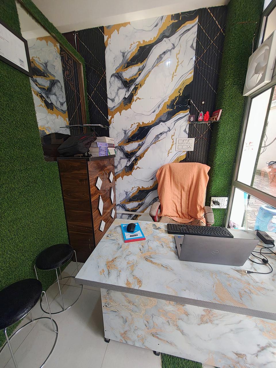 Reception desk at VidyaTech with a laptop and seating for visitors